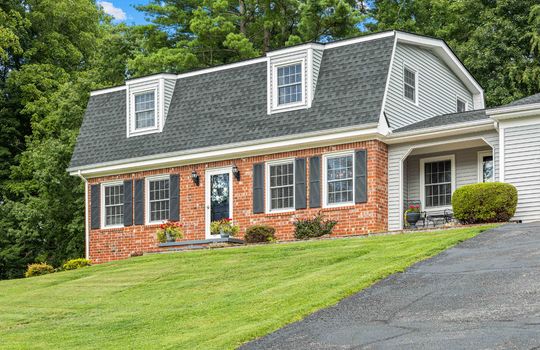 street view of home, dutch colonial home, brick exterior, vinyl siding