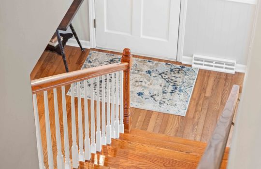 view at top of stairs toward entryway/front door