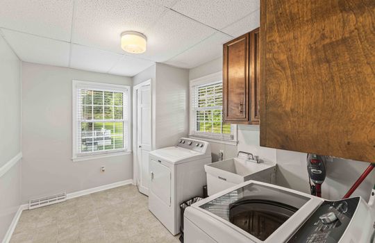 laundry area, cabinets, utility sink, window