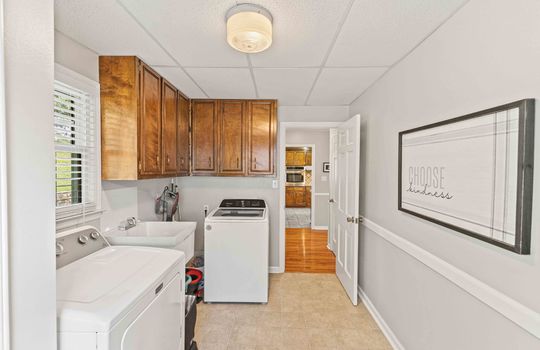 laundry area, cabinets, utility sink, window