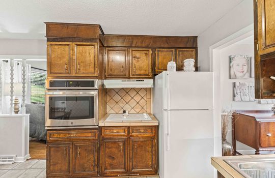 kitchen, refrigerator, wall oven, cooktop, cabinets, countertops