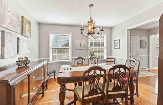 dining area, chandelier, chair railing, windows