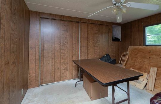 Bedroom, paneling walls, carpet, ceiling fan