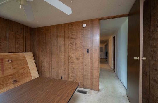 Bedroom, paneling walls, carpet, ceiling fan