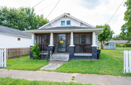 front view of home, cottage, vinyl siding, front porch, covered front porch, front door, concrete stairs, front of home