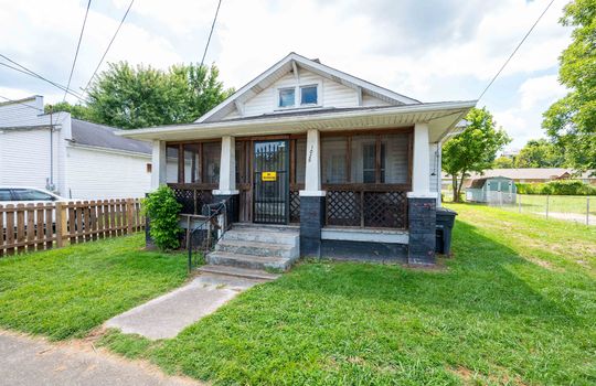 front view of home, cottage, vinyl siding, front porch, covered front porch, front door, concrete stairs