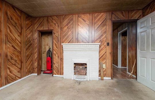 bedroom, carpet, paneling wall, fireplace, brick fireplace