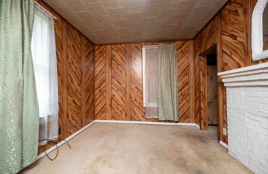 bedroom, paneling walls, brick fireplace, carpet, closet