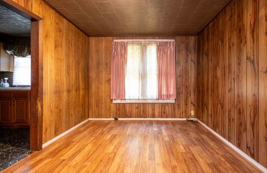 bedroom, laminate flooring, paneling walls, window