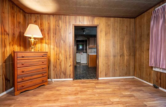 bedroom, laminate flooring, paneling walls