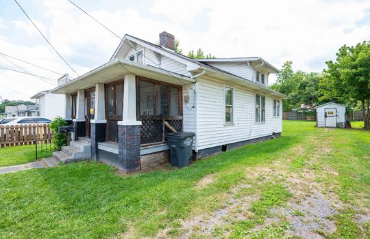 front porch, cottage, covered front porch, vinyl siding, driveway, outbuilding, front yard