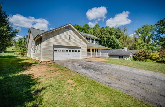 front yard, driveway, garage door, garage, two story traditional home, vinyl siding