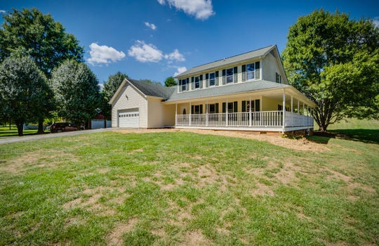 two story traditional home, vinyl siding, wrap-around porch, garage, garage door, front yard