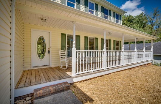 two story traditional home, wrap around covered porch, front door, vinyl siding