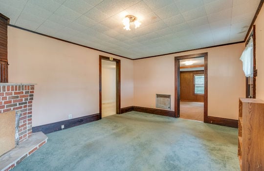 living room, fireplace, carpet, windows, doors