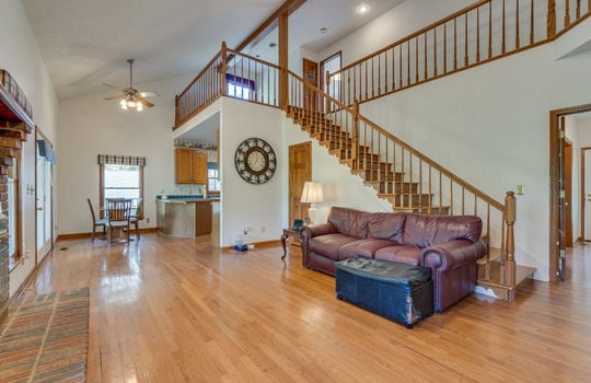 family room, hardwood flooring, stairs to upper level, breakfast nook, kitchen