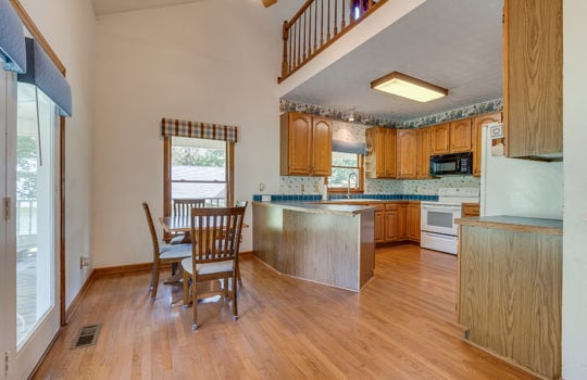 kitchen, breakfast nook, hardwood flooring, island, cabinets, countertops, range/oven, microwave