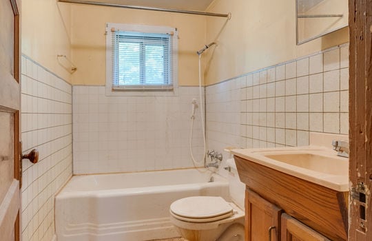 bathroom, vinyl flooring, tub/shower, toilet, sink