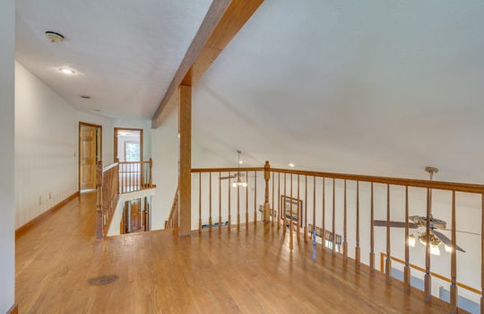 upper level loft space, hardwood flooring, wood beams