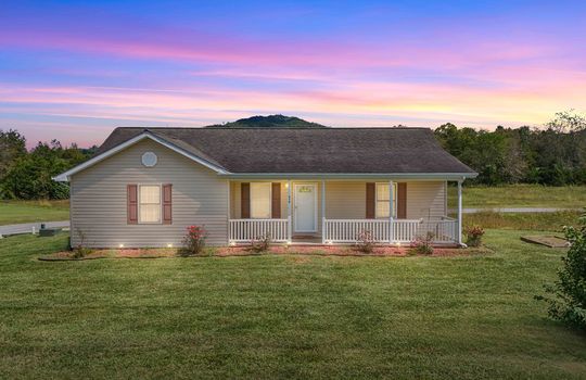 twilight photo, front yard, covered front porch, Ranch style home, vinyl siding, roof, mountain views.