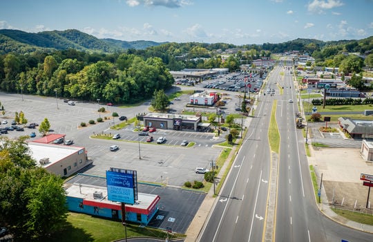 aerial view, restaurant, parking spaces, road, neighboring businesses