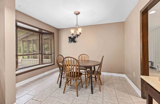 dining area, tile flooring, windows, chandelier