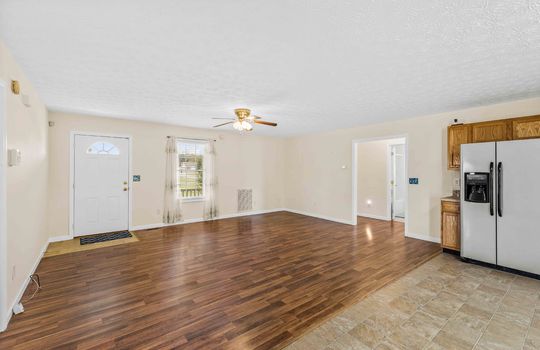 living room, front door, laminate flooring, window, ceiling fan