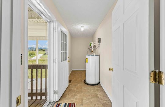 mud room/laundry room, water heater, vinyl flooring