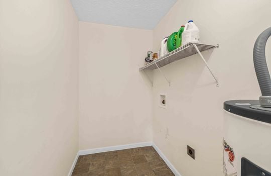 laundry area, vinyl flooring, wire shelving, water heater