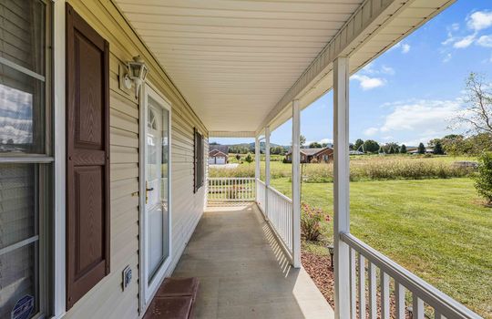 covered front porch, front door, storm door, concrete