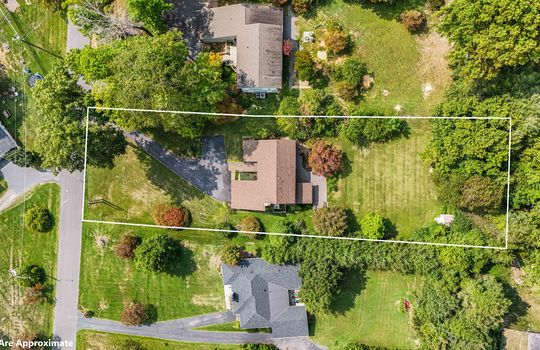 aerial view with property outline, roof, front yard, back yard