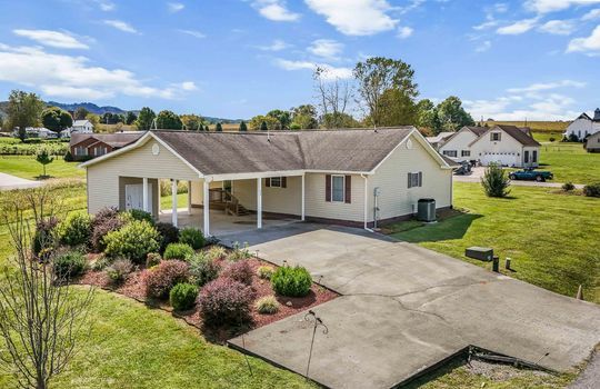 ranch style home, carport, covered carport, driveway, vinyl siding, roof, mountain views