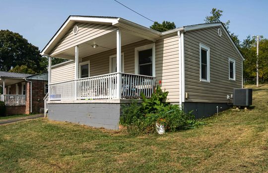 one level cottage, vinyl siding, covered front porch, front door