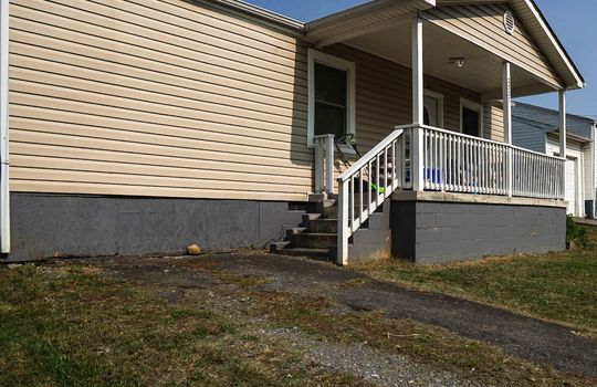 cottage, vinyl siding, covered front porch, driveway, steps