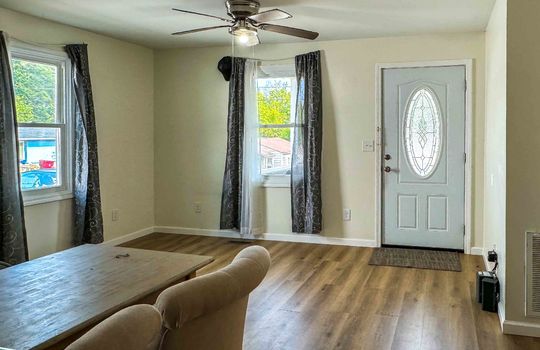 living room, luxury vinyl flooring, front door, windows, ceiling fan