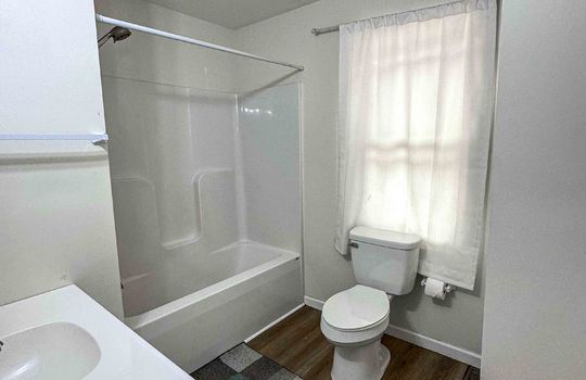 bathroom, luxury vinyl flooring, toilet, sink, tub/shower