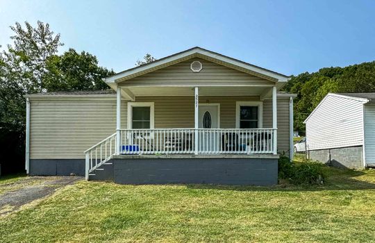 one level cottage, covered front porch, front door, front yard