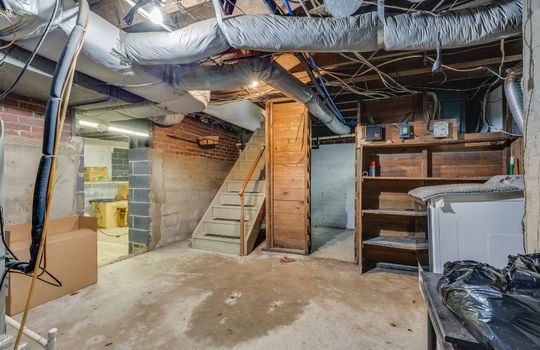 basement stairs, concrete flooring, storage shelves