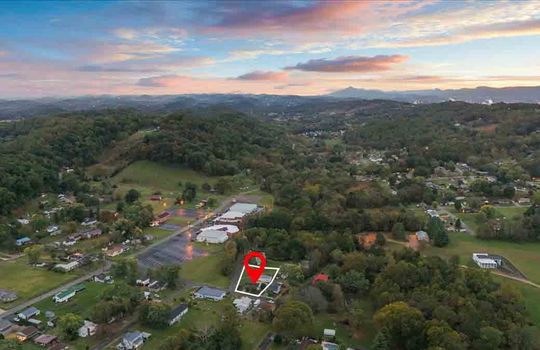 aerial photo of neighborhood, property outline, property marker, trees, homes, mountains