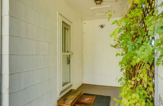 back exterior entrance, storm door, concrete porch