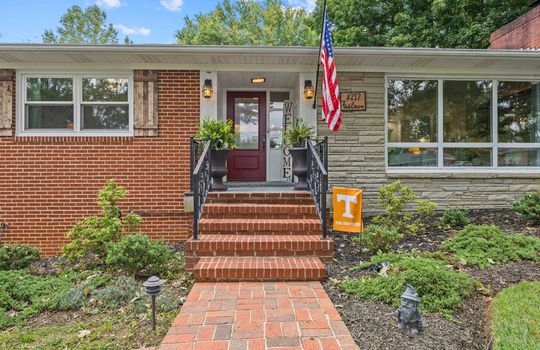 brick ranch, brick sidewalk, front steps, front door, windows, landscaping