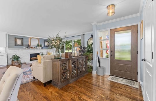 living room, hardwood flooring, fireplace, front door