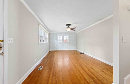 living room, hardwood flooring, ceiling fan, windows