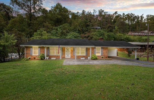 Twilight photo, brick ranch, covered front porch, sidewalk, driveway, carport, front yard, trees