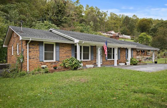 front left view of home, front yard, brick ranch, covered front porch, carport, sidewalk