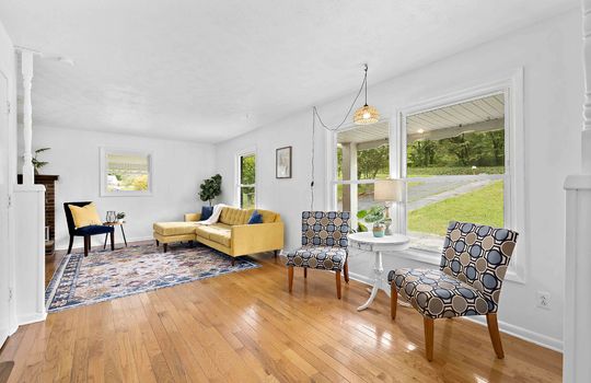 living room, large picture window seating area, hardwood flooring