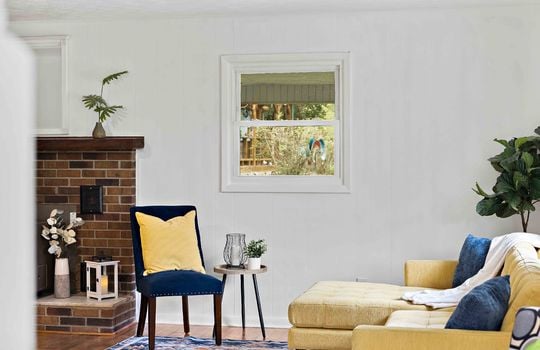 living room, window, hardwood flooring, brick fireplace