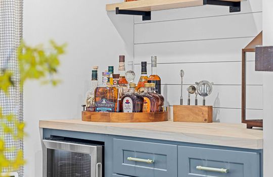 bar nook, shiplap wall, cabinet, mini beverage fridge