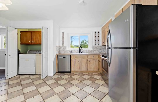 kitchen, tile flooring, refrigerator, dishwasher, stove/oven, refrigerator, cabinets, countertops, sink, window above sink, laundry space