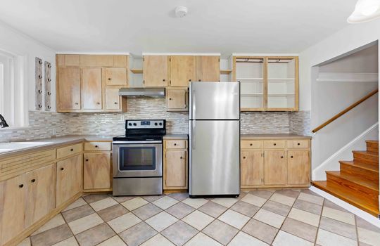 kitchen, cabinets, countertops, oven/range, refrigerator, stairs, tile flooring